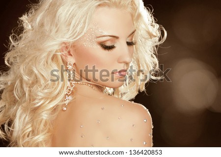Beauty Girl with blond curly hair. Fashion Art Woman Portrait