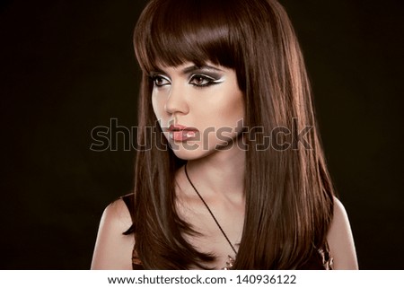 Hairstyle. Beautiful woman with long healthy brown hair.  Isolated on Black Background. Beauty Stylish Model Portrait