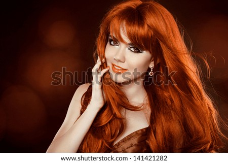 Hairstyle. Red Hair. Attractive smiling girl with long Curly Hair. Happy smiling woman.