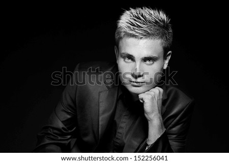 Fashion young handsome man. Black and white photo. Studio portrait.