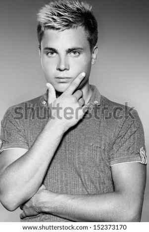 Fashion young handsome man. Black and white photo. Studio portrait.