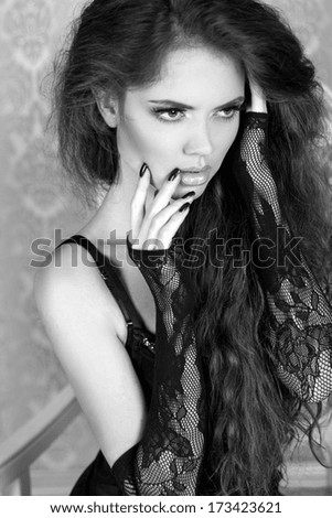 Black and white photo of sensual woman with long wavy hair