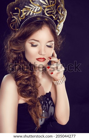Makeup. Manicured nails. Russian girl model in exclusive design clothes on manners old-Slavic. Close-up portrait.