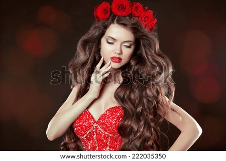 Long wavy Hair. Makeup. Beautiful Woman with chaplet of roses. Beauty Portrait. Brunette with long curly hairstyle and flowers