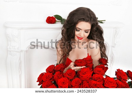 Beautiful smiling woman with makeup, red roses bouquet of flower. Fashion woman portrait. Valentines day.