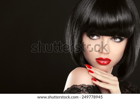 Stare. Fashion model girl face, beauty woman make up and red manicure. Bob black hairstyle. Brunette woman posing over black background.
