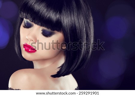 Makeup. Bob short hairstyle. Sexy girl model with naked shoulder posing over dark background. Blue eyeshadows closup.