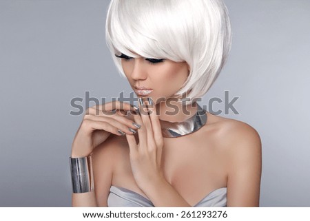 Blonde Bob Hairstyle. Fashion beautiful young girl in luxurious jewelry isolated on grey background. Fringe. Vogue Style.