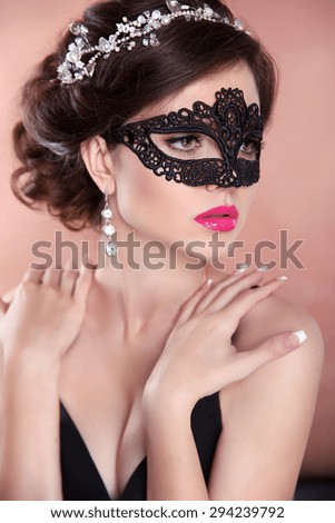 Beauty fashion girl model with mask. Makeup. Hairstyle. Jewelry. Sensual woman wearing venetian masquerade carnival mask