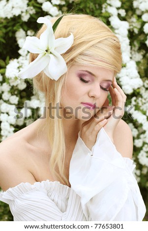 Portrait of the Beautiful romantic woman with flower. sensual touch
