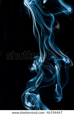 blue soft smoke against black background forming abstract pattern with copy-space on the left