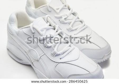 White athletic shoes on white background