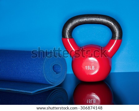 Red Kettle ball on blue background with mat roll