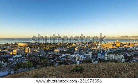 Cape Town\'s urban city scape during sunset over the stadium, harbor and V&A waterfront.