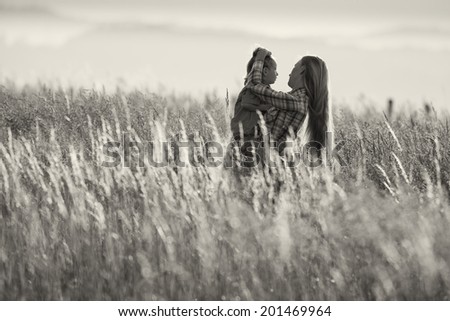 a woman with a child in the arms black and white photography