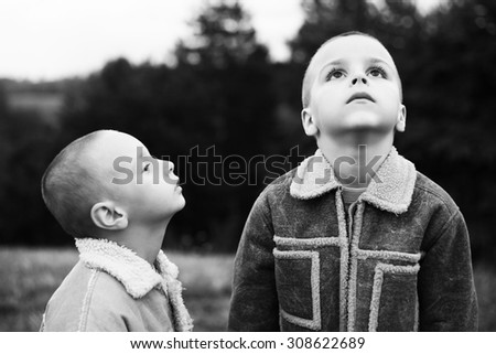 boys watch the sky black and white photography