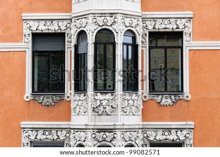 windows on a facade of a palace in Genoa, Italy