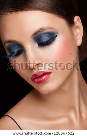 Portrait of attractive young woman with bright creative makeup