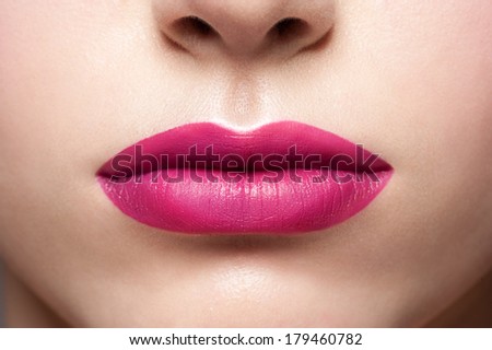 Closeup shot of sexy woman lips with bright pink lipstick