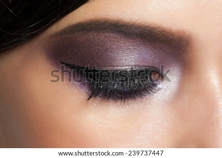 Closeup image of closed woman eyes with beautiful bright makeup. Makeup with eyeliner and falce eyelashes