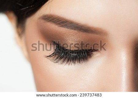Closeup image of closed woman eyes with beautiful bright makeup. Makeup with eyeliner and falce eyelashes