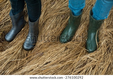 Rubber boots. Man and woman feet in rain boots outdoors