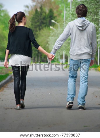 Young Couple Walking Together Hand By Hand In Park, Rear View Stock ...