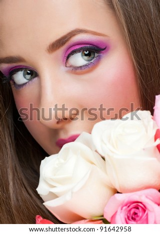 Portrait of sensual beautiful woman with roses and stylish bright make-up