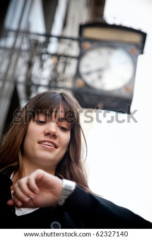 Woman checking the time on her watch ? outdoors