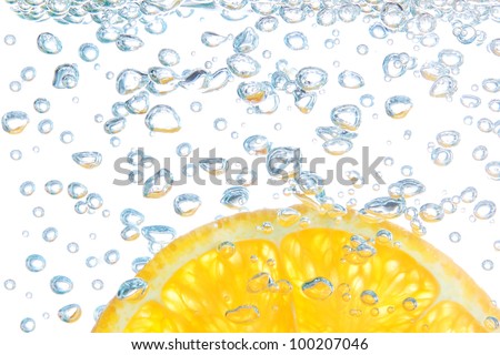 Orange in a liquid with bubbles. On a white background.