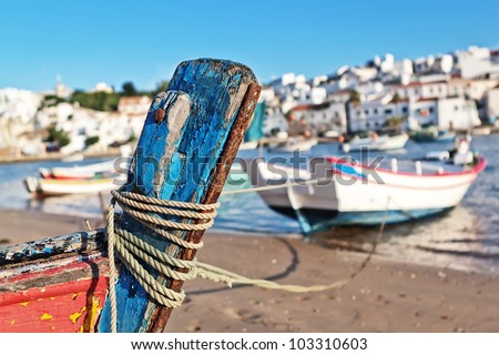 The mast of the old boat on the shore of Ferragudo. Seascape.