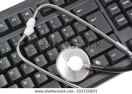 The keyboard for the computer and the elements of a closeup stethoscope. On a white background.