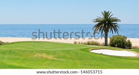Panoramic views of the golf course to the sea and palm trees. Portugal, Algarve.