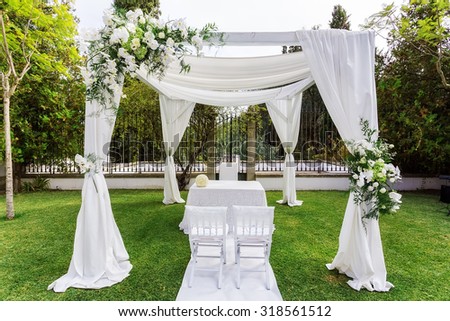 Silk tent for the wedding ceremony for the newlyweds. The garden in the countryside.