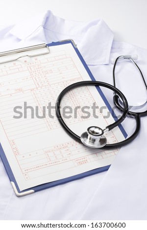 Stethoscope and medical records and lab coat medical