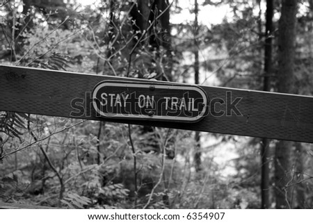 Caution sign in the woods - stay on trail