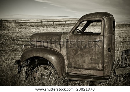 Classic farm truck left rusting in the field