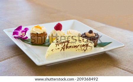 Plate with Desserts and a chocolate Banner saying Happy Anniversary