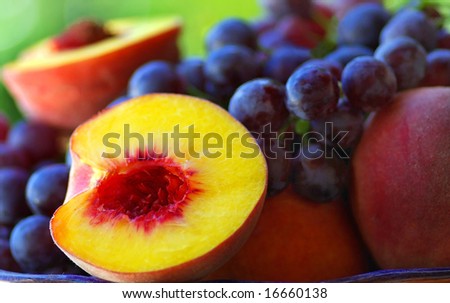 Half of peach with grapes.