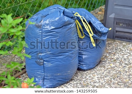 Plastic bin bags full of garden rubbish ready for recycling