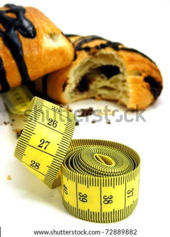 Chocolate danish pastry cake & measuring tape in diet concept