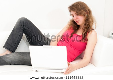 young woman sitting comfortable with laptop on couch