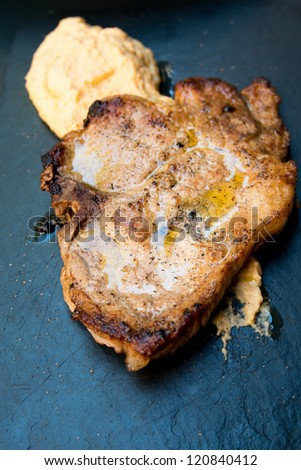 pork chop-delicious juicy pork chop with mash potatoes in black slate
