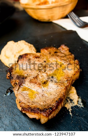 pork chop-delicious juicy pork chop with mash potatoes in black slate