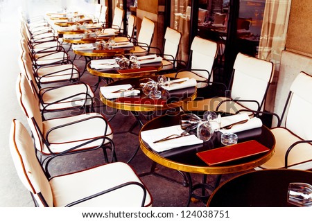Street view of a coffee terrace with tables and chairs,paris France - stock photo