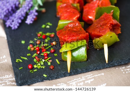 tasty meat and vegetables skewers on a slate plate