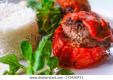 stuffed tomatoes with rice on a white plate