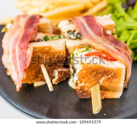 Sandwich with bacon - chicken, cheese and golden French fries potatoes