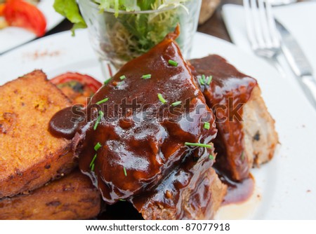 Grilled steak - Grilled meat ribs on the plate with hot sauce