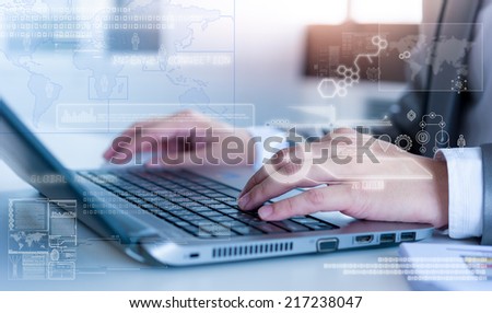 Close up of business man typing on laptop computer with technology layer effect